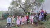 EMBLEMA. Dionisio Mesa, con los alumnos, después de la plantación del olivo en la escuela ermiteña.