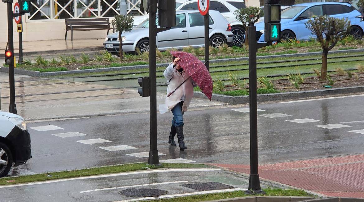 Una viandante se protege de las lluvias y el viento durante esta semana.
