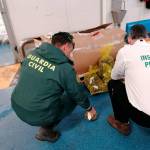 Agentes de la Guardia Civil con la mercancía intervenida. 