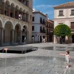 Niño refrescándose con el agua de una fuente en Plaza de España, en Andújar, donde se esperan alcanzar hoy los 41 grados. / Álvaro Guzguti / Diario JAÉN. 