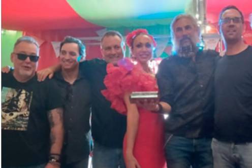 <i>José Lucini, Juanmi Medina, José Pozo, Susana Martínez, Dani Domingo, Manuel Medina y Óscar Rodríguez, recogieron una placa por parte de Diario JAÉN tras su actuación del año 2025 en la caseta de Diario JAÉN. </i>