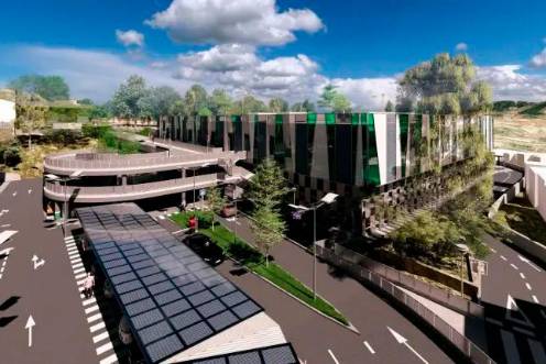 <i>Recreación de la vista trasera del centro de salud, donde se sitúa parte del aparcamiento en superficie con pasarelas de acceso y paneles fotovoltaicos.</i>