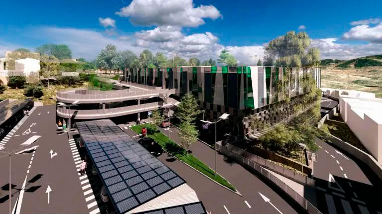 <i>Recreación de la vista trasera del centro de salud, donde se sitúa parte del aparcamiento en superficie con pasarelas de acceso y paneles fotovoltaicos.</i>