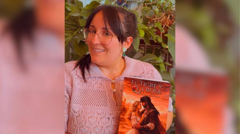 <i>Lydia Carpio posando con su libro “El Tigre y la Rosa: Crónicas de Karzadh”</i>