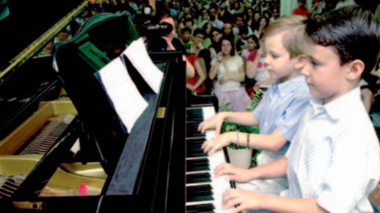 <i>Un grupo de niños de la escuela “Maestro Cebrián” interpreta una pieza con diferentes instrumentos. / Archivo Histórico de Diario JAÉN.</i>