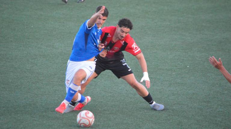 <i>El jugador del Linares Deportivo Iván Romero intenta solventar la entrada de un rival. / Tino Navas</i>