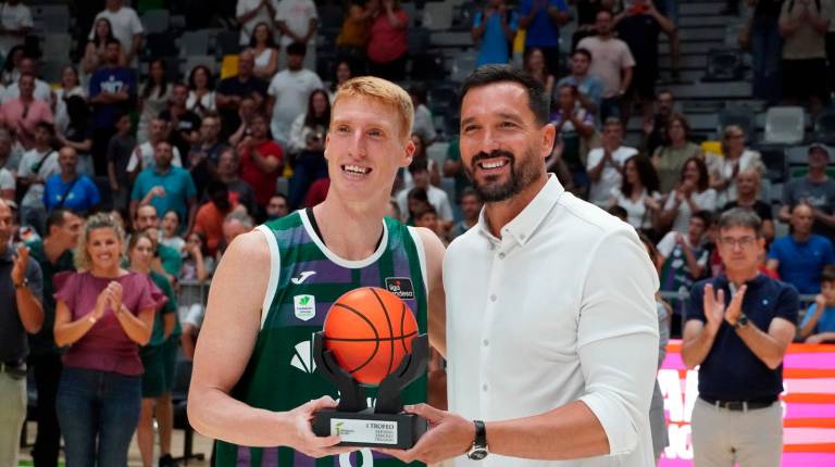 <i>El capitán del Unicaja Alberto Díaz recoge el trofeo de manos de Alfonso Sánchez. / Juanjes García / Diario JAÉN. </i>