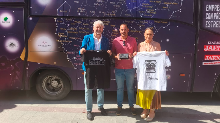 <i>Juan Espejo, Luis Miguel Carmona y María Luisa Segado, frente al autobús “Empresas con Estrella” y sosteniendo camisetas conmemorativas y un obsequio de Diario JAÉN. / Agustín Muñoz / Diario JAÉN.</i>