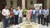 Autoridades y organizadores posan con los maillots en la sede de la Delegación del Gobierno Andaluz.