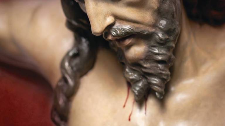 <i>Cartel con la imagen del Cristo.</i>