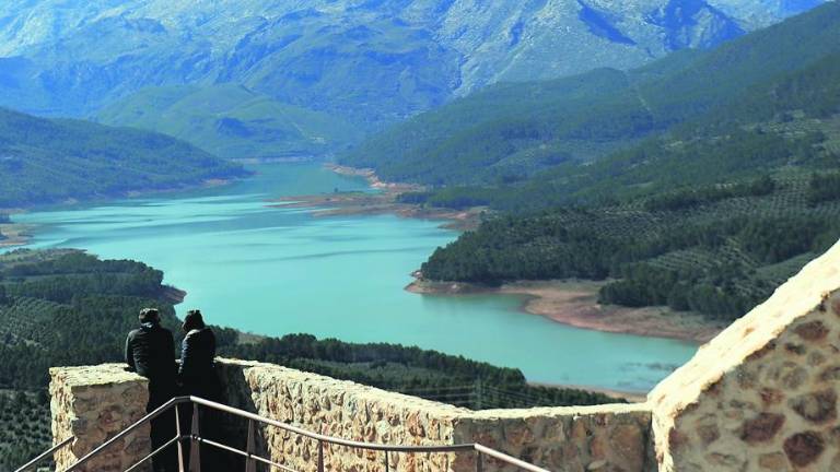 Una roca entre el cielo azulado y la sierra verdosa